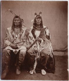 two native american indians sitting next to each other