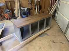 a workbench in a garage with tools hanging on the wall