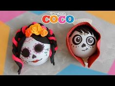 two decorated eggs sitting next to each other on top of a table with the words coco painted on them