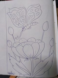 an open book with drawings of flowers on it