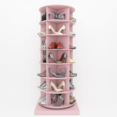 a pink shoe rack with several pairs of shoes on top and bottom shelves in the middle