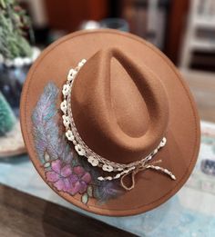 Felt/wool hat hand burned with feather and flower pattern. Hand colored and hand made beaded band. Adjustable and nice quality. beautiful deep tan color ... fun for any event, awesome Christmas gift! Handmade Brown Fedora With Short Brim, Brown Handmade Fedora With Short Brim, Handmade Felt Hat For Winter Rodeo, Hand Painted Brown Wide Brim Hat, Custom Brown Hat Bands For Festival, Brown Hand Painted Short Brim Hat, Artisan Brown Hat Bands For Winter, Vintage Brown Handmade Hat Bands, Vintage Handmade Brown Hat Bands