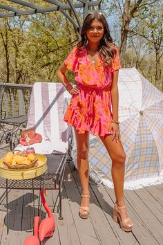 You are guaranteed to look sassy and sweet in this darling hot pink romper featuring lightweight material patterned with a pretty orange floral print, a faux wrap bodice with a v-cut neckline, short loose sleeves, a cinched elastic waistline with a tie closure, a keyhole accented upper back with a button closure, and a relaxed shorts silhouette that ends in straight upper-thigh length hemlines! on products Measurements XS : Bust 30", Hip 32", Inseam 2", Length 30", Sleeve Length 7", Waist 28". S : Bust 32", Hip 34", Inseam 2", Length 31", Sleeve Length 7", Waist 30". M : Bust 34", Hip 36", Inseam 2", Length 32", Sleeve Length 7.5", Waist 32". L : Bust 36", Hip 38", Inseam 2", Length 33", Sleeve Length 7.5", Waist 34". XL : Bust 38", Hip 40", Inseam 2.5", Length 34", Sleeve Length 8", Waist Hot Pink Romper, Pretty Orange, Orange Floral Print, Pink Romper, Pink Rompers, Loose Sleeves, Sweet Floral, Floral Romper, V Cuts