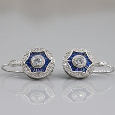 Vintage Antique Art Deco Earrings, Milgrain Earrings, Round & Blue Sapphire Lever Back 1920's Earrings, 925 Sterling Silver Earrings  **Returns and Refunds** 30-Day Returns All our diamonds have Paid 6 Months guarantee! We are fully behind every diamond and piece of jewelry that we sell. It is vital for us that you are totally happy with your purchase. If you are not 100% happy with your purchase, you can return it to us within 30 days of purchase for a full refund or exchange. Happy Shopping With VNVJEWELS ✶ Our All Jewelry Is handcrafted In such a way that it gives special touch to your dream gift. Thank You Visit Again 𝐂𝐀𝐍𝐂𝐄𝐋𝐋𝐀𝐓𝐈𝐎𝐍𝐒 𝐏𝐎𝐋𝐈𝐂𝐘 We Charge 10% of Order Value if any Order Canceled Within 24 Hours of Purchase. We Charge 20% of Order Value if any Order Canceled Classic Drop Earrings For Vintage Events, Art Deco Dangle Earrings For Anniversary, Art Deco Sterling Silver Dangle Earrings, Vintage Sterling Silver Diamond Earrings For Anniversary, Art Deco Hallmarked Drop Earrings, Hallmarked Art Deco Earrings For Anniversary, Art Deco White Gold Diamond Earrings, Art Deco Formal Earrings Hallmarked, Art Deco Pierced Jewelry For Anniversary