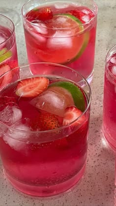 three glasses filled with different types of fruit and ice on top of a marble table