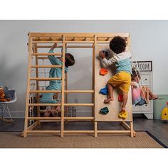 two children climbing up the side of a wooden bunk bed in a play room with toys