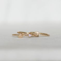 Diamond petal stacking rings in 14k gold. Sweet little handmade petals and a tiny sparkly diamond on hammered bands. Details: *Bands - Choose 1.3mm OR 1.6mm *Diamond - 2mm white - conflict-free *Gold - Eco-friendly, recycled Made to order. Production time 2-3 weeks...this does not include the time it will take to ship your ring to you. Thanks for looking! Lilian Delicate Gold Stackable Rings With Rose Cut Diamonds, Stackable Rings In Recycled Gold, Delicate Gold Stackable Rings With Gemstones, Dainty Yellow Gold Stackable Rings With Rose Cut Diamonds, Delicate Tiny Stackable 14k Gold Rings, Delicate Stackable Rings With Single Diamond, Delicate Stackable 14k Gold Rings With Rose Cut Diamonds, Delicate 14k Gold Stackable Rings With Rose Cut Diamonds, Delicate Yellow Gold Stackable Rings With Single Diamond