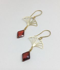 "Lovely gold Vermeil earrings with red Cubic Zirconia (CZ). These earrings evoke the romantic style of a bygone era known as the 1920's where Art Deco design was all the rage! The Vermeil fan shape is both feminine and stylish with a clear red CZ gemstone that is faceted and cut into a diamond shape that enhances its pure red color! Simply stunning, you will not go unnoticed while wearing these beauties. Perfect for your next holiday event or any other occasion. These earrings are light weight a Art Deco Jewelry 1920s, Red Art Deco, 1920s Jewelry, Heavy Earrings, Deco Earrings, Bygone Era, Red Art, Cz Jewelry, Art Deco Earrings