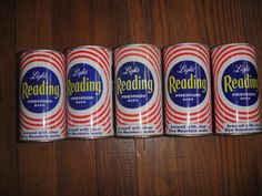 six cans of reading beer lined up on a table