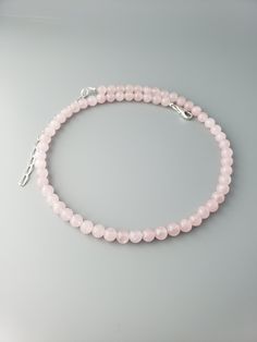 "This  round smooth Madagascar Rose Quartz beads are about 6mm.  The length is 16\" plus 3\" extension.  Sterling silver chain and lobster clasp.  Madagascan Rose Quartz is a rare, classic 'rose' pink gemstone from Madagascar's Antananarivo Province. A romantic gemstone historically known as the 'gem of love' is noted for its superior quality.  Link to the shop  https://www.etsy.com/shop/CrystalRise" Elegant Round Pink Crystal Necklace, Elegant Rose Quartz Round Crystal Necklaces, Elegant Rose Quartz Round Crystal Necklace, Elegant Round Rose Quartz Crystal Necklace, Elegant Rose Quartz Round Beads Crystal Necklace, Elegant Rose Quartz Crystal Necklace With Round Beads, Classic Pink Round Necklace, Pink Round Necklace With Lobster Clasp, Elegant Pink Necklaces With 8mm Beads