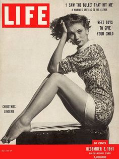 a magazine cover with a woman sitting on the back of a suitcase and holding her hand to her head