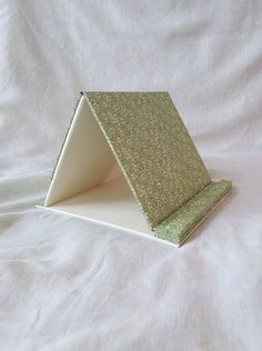 a small green and white object on a white sheet