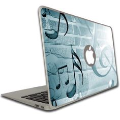 an apple laptop computer with musical notes on it