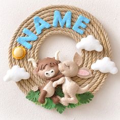 a rope wreath with a stuffed animal and name on it