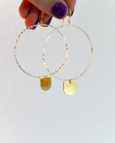 "These 14k gold fill geometric hoops are every girl's dream. As light as a feather, you can wear these from day into the evening. They're classic, chic, and effortless. The half-circle dangle charm is the cutest little addition to the hoop that makes it unique and full of magic. ▲ 14k gold fill 2\" hoops ▲ 24k gold plated brass charm ▲ Drop length: 3\" ▲ Weight: 1/8 oz ▲ Hypoallergenic ▲ Gift-ready in a beautiful white jewelry box ▲ Handmade just for you SHOP FIERCE FORWARD JEWELRY: https://www. Trendy Dangle Hoop Earrings In Brass, Everyday Nickel Free Dangle Hoop Earrings, Adjustable Hoop Earrings For Everyday, Modern Hammered Hoop Earrings As Gift, Trendy Brass Dangle Hoop Earrings, Modern Hammered Hoop Earrings For Gift, Modern Hammered Hoop Earrings Gift, Modern Brass Hoop Earrings For Everyday, Nickel-free Dangle Hoop Earrings For Everyday