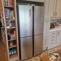 a large stainless steel refrigerator in a kitchen