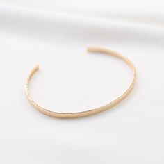 "14K gold cuff bracelet. 14K Gold Minimalist Cuff Bracelet * 14K solid gold. It is about 3mm x 1mm Please select the size of your wrist. If your wrist is 6\", please purchase 6\" bracelet. (If you order a 6\" bracelet, actual cuff length will be 5\" plus 1 inch opening.) Please read our policies before you place your order. https://www.etsy.com/shop/SashJewelry/policy?ref=shopinfo_policies_leftnav To see other Mother daughter necklace set click here: https://www.etsy.com/shop/SashJewelry?section Minimalist Open Cuff Bracelet, Minimalist Hammered Bracelet Bangle, Minimalist Hammered Bangle Bracelet, Minimalist Open Cuff Bangle For Everyday, Hammered Minimalist Bangle, Minimalist Stackable Gold Bangle Bracelet, Minimalist Hammered Cuff Bracelet As Gift, Everyday Gold Hammered Cuff Bracelet, Minimalist Hammered Cuff Bracelet Gift