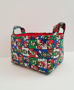 a multicolored bag with mario and luigi's faces all over the pattern