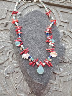 "Colorful gemstone necklace in rich vibrant colors that will remind you of sea, beach an summer. This necklace will look great with white ,black, blue and anything in-between. It is had strung with chalcedony brioletts, fresh water pearls, coral and sterling silver elements. This is a real treat for a lady who likes one of a kind and not so typical pieces. The necklace is a choker style and measures 17\" Please see matching earrings https://www.etsy.com/listing/1557944640/blue-chalcedony-peals-a Ocean-inspired Colorful Bead Necklaces For Gifts, Ocean-inspired Colorful Beads Necklace For Gift, Ocean-inspired Colorful Beads Necklace Gift, Gift Ocean-inspired Colorful Beads Necklace, Blue Gemstone Necklace For Beach, Ocean-inspired Multicolor Beaded Necklaces, Unique Gemstone Jewelry For The Beach, Handmade Ocean Color Necklaces For Jewelry Making, Multicolor Beaded Ocean-inspired Jewelry