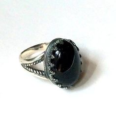 "My first love Amazing silver ring. A great combination of the deep black onyx set in the oxidized silver bezel. (R2058). © 2011-2015, Artisanimpact Inc. All rights reserved. Construction & Dimensions: Sterling silver, onyx. Approximate band width: 3mm - 10mm Top part of the ring 15mm (0.59\") x20mm (0.78\"). We can make any size, including quarter sizes. Please just indicate the requested size in the order. About our jewelry Artisanlook offers an exciting collection, designed and made by ar Spiritual Birthstone Ring For Formal Occasions, Vintage Jewelry With Large Stone In Open Ring, Classic Large Stone Promise Ring, Heirloom Sterling Silver Rings With Stone Setting, Classic Wedding Ring With Large Stone, Formal Adjustable Ring With Large Stone, Bohemian Sterling Silver Oval Cabochon Rings, Vintage Sterling Silver Rings With Large Stone, Elegant Large Stone Sapphire Ring Gift