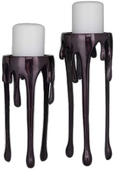 two candle holders with white candles dripping from them