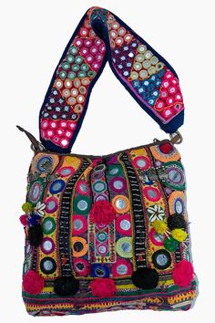 a multicolored purse with tassels and pom - poms on it