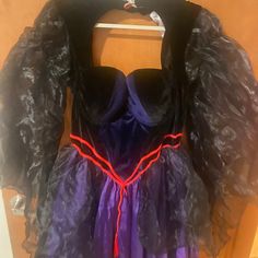 a purple dress with black and red trim