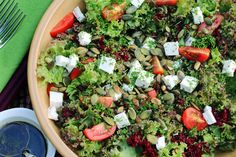 a salad with tomatoes, lettuce and feta cheese