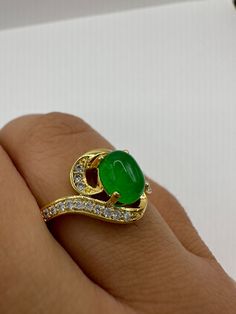 vintage green fun jade ring  Setting is a golden finished bronze setting  This is one of my hand re finished treasures. Salvaged from vintage.  Size  9.5 Re sizing can be done for a $20 fee and may take up to a week.  Engraving is $4 per letter.  Thank you for supporting a veteran's small business. All jewelry is shipped free within the US in a stylish gift box Vintage Green Rings With Stone Setting, Gold Jade Emerald Ring, Vintage Jade Jewelry For Anniversary, Antique Gold Emerald Cabochon Ring, Antique Gold Emerald Ring As Gift, Vintage Green Open Ring Jewelry, Antique Handmade Green Emerald Ring, Antique Green Emerald Ring Collectible, Collectible Gold Emerald Gemstone Ring