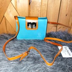 Genuine Italian Leather. It Is New With Tag But It Does Show Some Creasing , As Shown In Pictures . The Tag Was Pulled Off By Accident So It Was Taped . Light Blue Top Handle Shoulder Bag For Travel, Luxury Blue Pouch Satchel, Luxury Light Blue Leather Shoulder Bag, Luxury Blue Shoulder Bag With Phone Holder, Luxury Blue Shoulder Bag With Mobile Phone Bag, Blue Shoulder Bag For Mobile Phone On-the-go, Brown Leather-handled Crossbody Box Bag, Blue Rectangular Flap Bag, Blue Satchel Flap Bag For Shopping