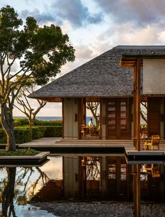 a house sitting next to a body of water