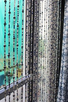 beaded curtains are hanging in front of a window