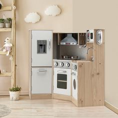 a toy kitchen with white appliances and wooden shelves on the wall, in a playroom