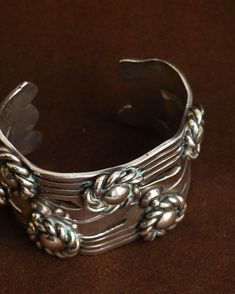 Sterling silver Approx. 2.5" inside, 1.5" open Spratling described this stunning design as "a wide Aztec bracelet with framed buttons" according to Goddard's spratlingsilver.com. It was one of Spratling's most popular designs in the 1930's - 1940's and still is today. Vintage Handmade Wide Band Jewelry, Handmade Vintage Wide Band Jewelry, Unique Wide Band Collectible Jewelry, Silver Heirloom Wide Band Jewelry, Vintage Adjustable Wide Band Jewelry, Handmade Sterling Silver Cuff Bracelet Collectible, Vintage Sterling Silver Wide Band Jewelry, Handmade Sterling Silver Cuff Bracelet For Collectors, Silver Polished Cuff Bracelet For Ceremonial Use