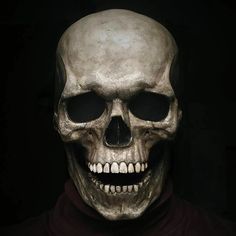 a man wearing a skeleton mask in the dark