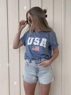 USA T-Shirt / Light Blue / Fourth of July shirt https://etsy.me/2SSfg76 #blueusashirt #usaflagshirt #patriotictshirt #memorialdayshirt #usatshirt #americatshirt #fourthofjulyshirt #americashirt #july4th #redwhiteblue Shorts And Tshirt Outfits, Blue Jean Shorts Outfit, Jean Short Outfits, July Outfits, Graphic Tee Outfits, Fourth Of July Shirts, Usa Shirt, T Shirt And Jeans, Tshirt Outfits