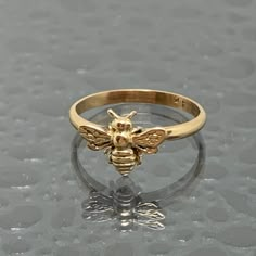 This is a 14kt solid gold Honey Bee Ring made in our studio in Ohio. These rings are available in various sizes and are made to order, so allow us a couple days extra for time in our studio. This ring will be a fantastic gift for yourself or that someone special. Keep in mind the Bee is very mischievous and can get caught in loose clothing and hair on occasion. We have tried various methods to eliminate this by offering the option of no antennae. Free Insured Priority Shipping to the US. Quirky Ring, Bee Ring, Bee Jewelry, Gold Bee, Fashion Statements, Authentic Jewelry, Gifts For My Wife, Holiday Deals, Girly Jewelry