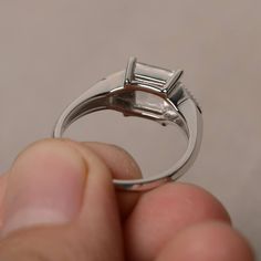 This is a gorgeous handmade creation. Its beauty is its simplicity & Elegance. The 7*7 mm square shape faceted natural white topaz is crafted in solid sterling silver and with rhodium plated. All item is sent in a beautiful gift box If you have any idea of design your ring,pls contact me directly. You can realize more lovely stuff clicking the link https://www.etsy.com/shop/knightjewelry?refshopsection_shophome_leftnav Please leave the correct address and you phone number for delivering succ White Square Cut Moissanite Ring, Square Cut Diamond White Promise Ring, White Topaz Princess Cut Diamond Ring As Gift, Square Cut Topaz Ring For Wedding, Princess Cut White Topaz Diamond Ring As A Gift, Modern Square Cut Emerald Ring For Wedding, Square Cut Topaz Wedding Ring, Wedding Square Cut Topaz Ring, Rectangular Moissanite Ring In White Gold