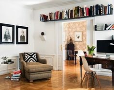 a living room filled with furniture and bookshelves on top of it's shelves