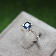 * Material: 925 Sterling Silver * DETAILS ✥ Handmade Ring ✥ - Center Stone: Lab Blue Sapphire  - Center Stone Size: 6 MM - Center Stone Shape: Cushion  - Side Stone: CZ Diamond  ✥ O T H E R ∙ I N F O R M A T I ON ✥ ♦ Your item will be nicely packed to gift in elegant jewelry boxes. ♦ Custom Order We can make custom rings in almost any shape and style. If you want a specific model, please send us a clear picture and we will do our best. ♦ Delivery All Item will be Shipped within 3 to 5 Days after Ring Cushion, Deco Blue, Cushion Cut Ring, Blue Sapphire Ring, 925 Silver Ring, Blue Sapphire Rings, Cz Diamond, Elegant Jewelry, Cushion Cut