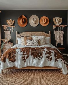 a bed with hats on the wall above it and other items hanging on the wall