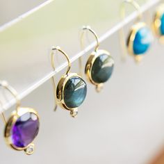 Inspired by our statement Dropping Circles earrings, we designed the Tini Mini Drops to be worn with all your everyday looks. Each semi-precious gemstone sits next to a small cubic zirconia cabochon for a subtle pop of sparkle. Add them to any outfit for colorful fun! Details Lightweight drop earrings Made of genuine labradorite and cubic zirconia stone Skillfully handcrafted in 14k gold over recycled brass Our gold plating is twice as thick as the industry standard and finished with an E-Coatin Circle Earrings, Semi Precious Gemstones, Gold Plating, Natural Materials, Everyday Look, Labradorite, Semi Precious, Cubic Zirconia, Gold Plate