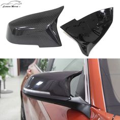 the side view mirror on a car that has been painted black and is next to an orange