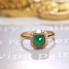 *Condition: Brand new *Center Stone: Natura Emerald from Zambia, approx 0.68ct, 6x6mm (IF clarity, 5A color) *Side Stone: Natural White Diamond, Round Cut & Baguette Cut (VS1 clarity and F color) *Gold Weight: 3.41g (depand the ring size) *Ring Dimension: approx 10x10x8.5mm *Metal Purity: Can be select Each piece is made-to-order with care and special attention to detail. all items are made with conflict-free diamonds and gems. Size: made to order The item will be gift wrapped and shipped. - Elegant Moissanite Emerald Ring For Proposal, Yellow Gold Ring With Baguette Cut Halo Setting, Elegant Emerald Ring With Halo In Cubic Zirconia, Elegant Emerald Cubic Zirconia Ring With Halo, Elegant Emerald Halo Ring With Cubic Zirconia, Elegant Yellow Gold Emerald Ring For Proposal, Luxury Emerald Rings With Halo Detail, Emerald Crystal Ring In Yellow Gold, Yellow Gold Emerald Crystal Ring