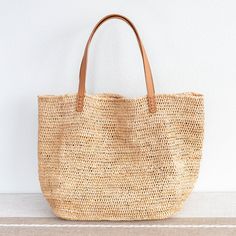 Chic large straw woven tote bag perfect for all occasions. This tote bag is sure to keep up with your busy lifestyle, providing a lightweight and durable design with a classic aesthetic. It’s the perfect way to stay organized while making a stylish statement. Natural Soft Raffia Straw Genuine leather handlesNo linerDimensions: 14"H x 20"W x 8.5"D10" handle drop Designer Style ID: 8583 Large Straw Woven Tote Bag, Summer Bag, Everyday Shoulder Bag, Beach Bag Everyday Straw Bag With Double Handle, Natural Bags With Braided Handles For Daily Use, Everyday Large Capacity Straw Bag With Long Handle, Natural Bags With Rolled Double Handles, Chic Beach Bag With Rolled Handles For Daily Use, Everyday Bag With Braided Handles In Natural Fiber, Everyday Basket Bucket Bag With Braided Handles, Everyday Bag With Braided Handles And Natural Fiber, Natural Tote Bag With Rolled Handles