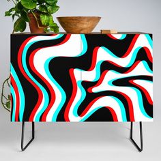 a colorful cabinet with a plant on top