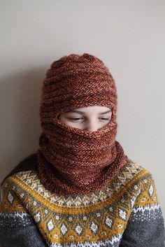 a person wearing a knitted hat and scarf