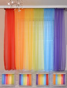 the rainbow curtains are hanging on the wall