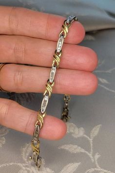 This is a fine vintage 10k yellow and white gold (marked and electronically tested) bracelet set with pretty baguette diamonds (tested as diamonds). Each of the ten (10) white gold oval links are set with seven (7) tapered straight baguette diamonds with an average colour grade of J-K and a clarity of approximately I1. My estimate is the bracelet contains a total of approximately 1.5 or slightly more carats of diamonds. This classic bracelet weighs 7.37 grams and measures 7.0 inches in length wi Gold And Diamond Bracelet, Sweet Ring, Classic Bracelets, Special Ring, Bracelets Gold Diamond, Baguette Diamonds, Wedding Jewelry Bracelets, Box Clasp, Wedding Bracelets