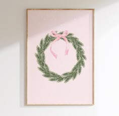 a pink wall with a wreath on it and a pink ribbon hanging from the front